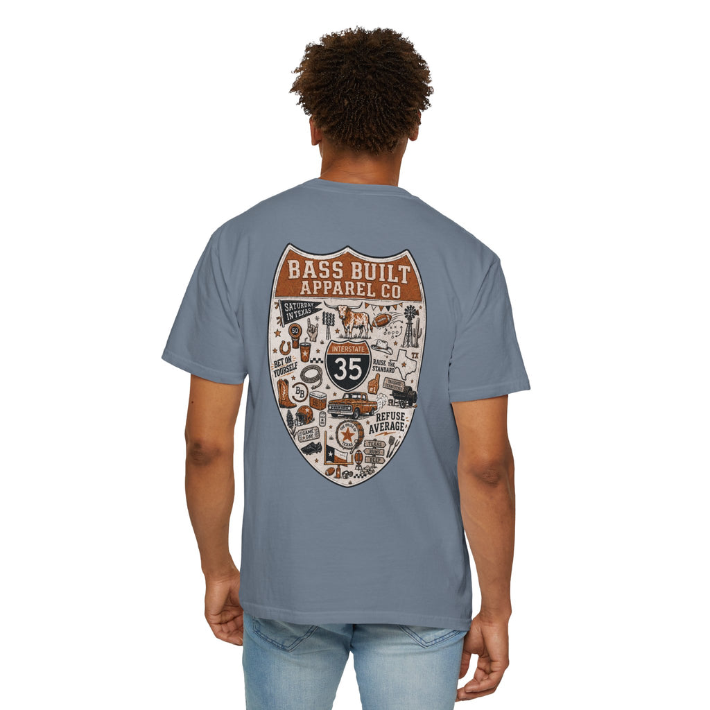 Light blue crew neck T-shirt with large shield graphic on back, worn by model