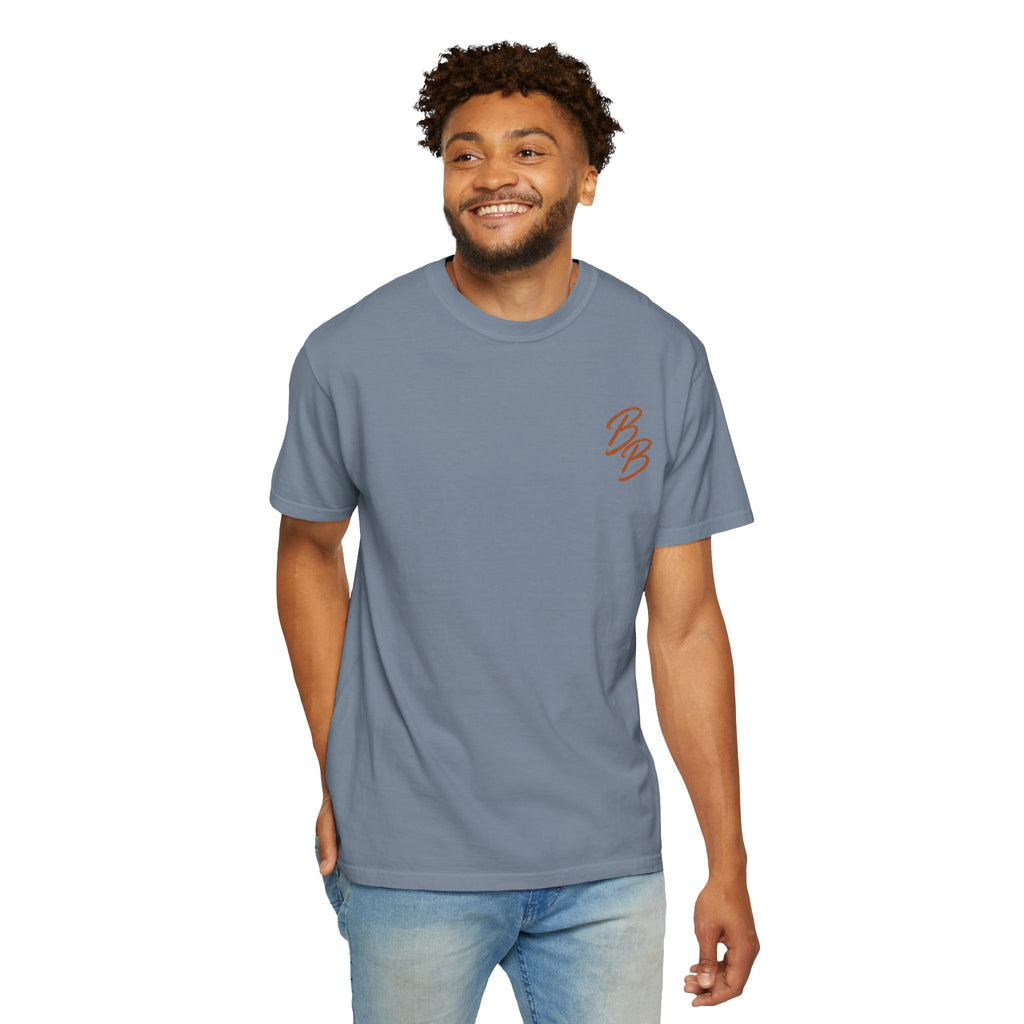 Dusty blue T-shirt with orange script logo on left chest, worn by model