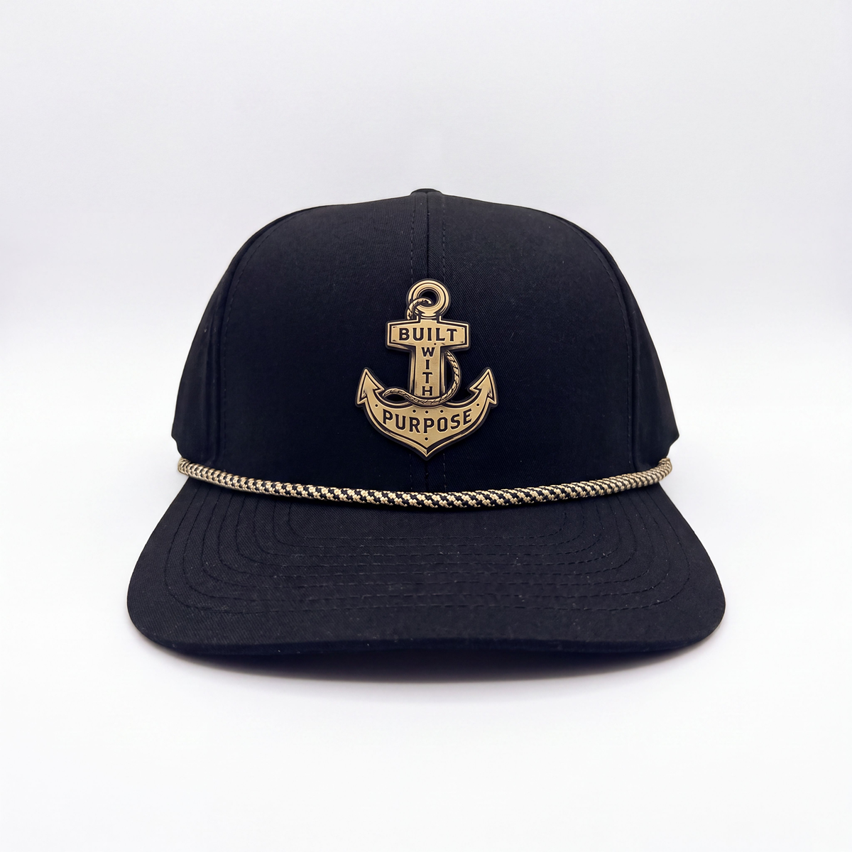 Black anchor baseball cap with gold crest patch and braided trim along brim