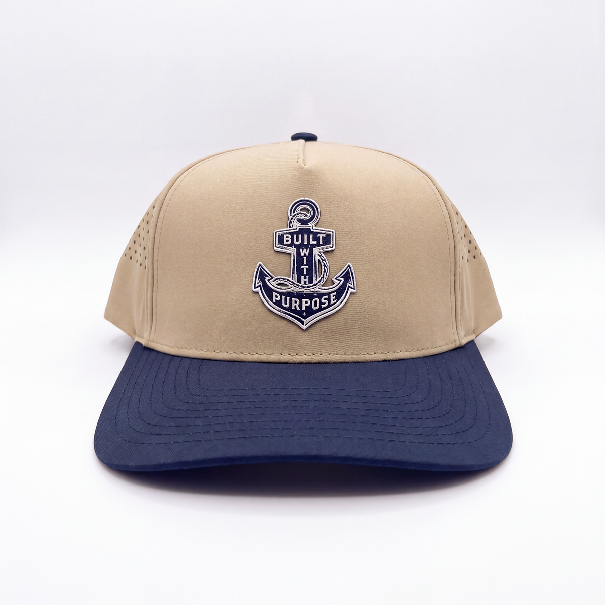 Sand and navy-blue baseball cap with centered anchor patch and curved brim
