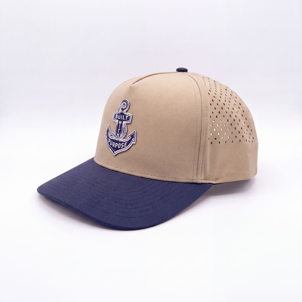 Sand and navy-blue two-tone baseball cap with anchor emblem and mesh side vents